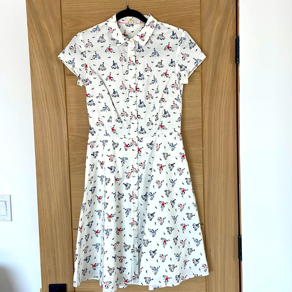 Print includes mini Vespa like scooters with women riding